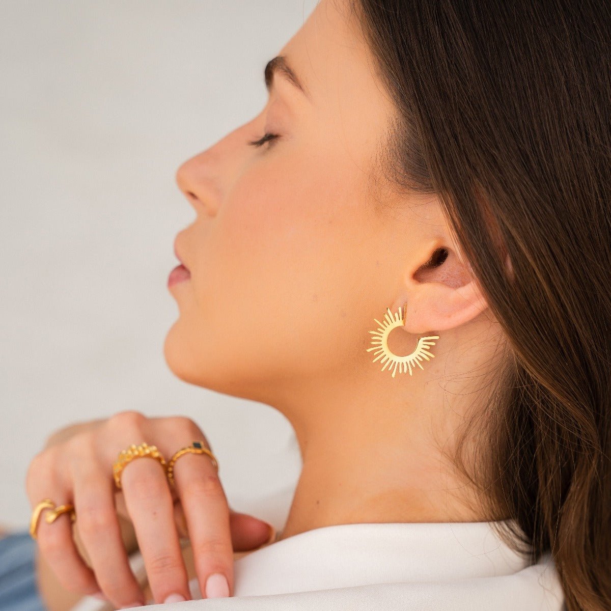 Vanta Crest Hoop Earrings in gold-tone, close-up detail view